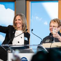 Lynn Blue toasting on stage at the Lynn M. Blue Connection Naming Ceremony
